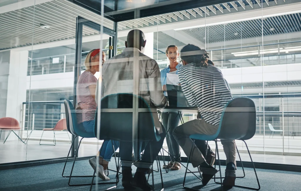 A team of co-workers working in a board room.